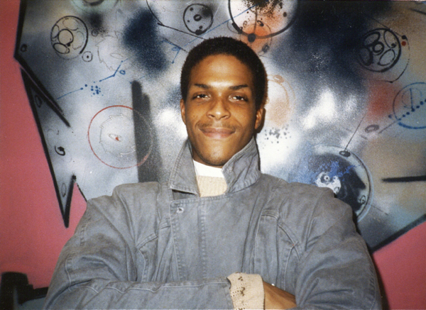 Brooklyn guy in front of mural by Futura 2000. (Early 1980s)